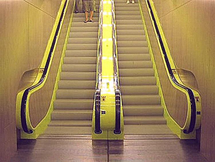 Symmetrical photo of the bright green escalators